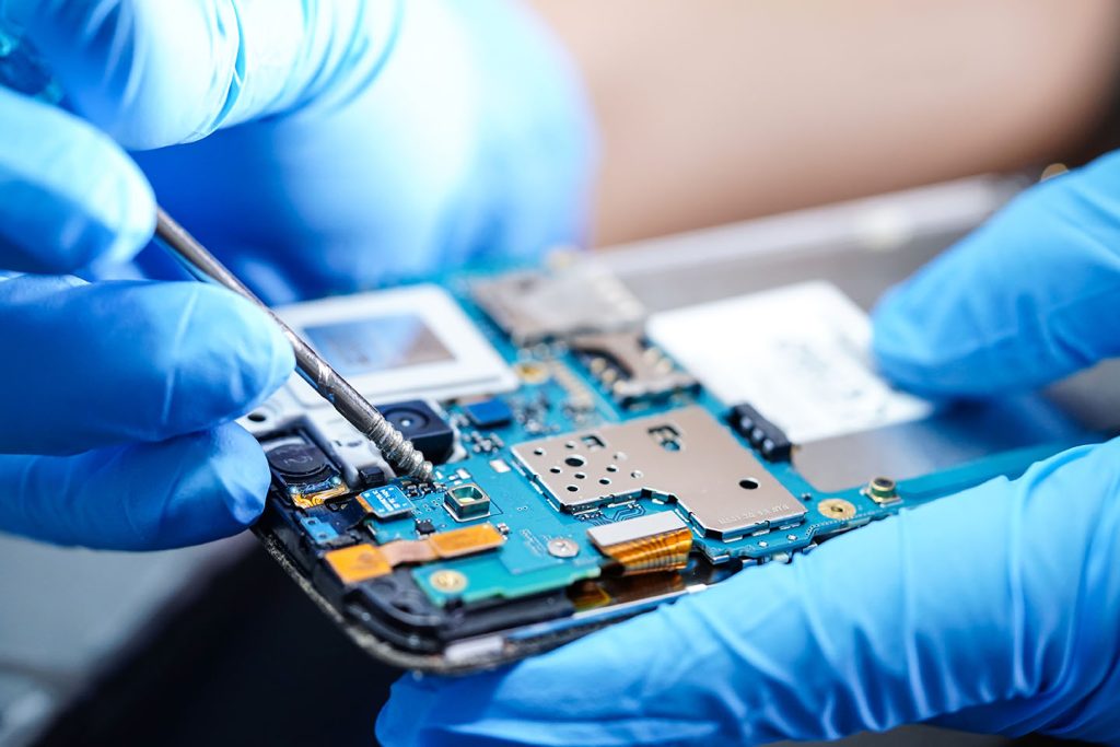technician working on a phones motherboard