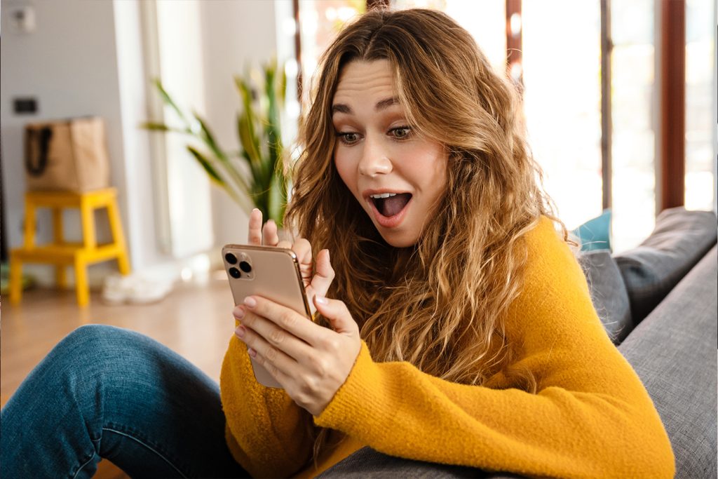 woman looking surprised at a message she received