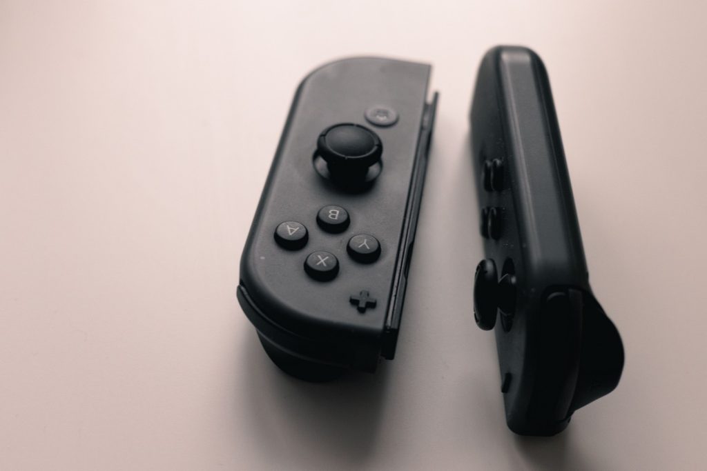 Nintendo joy con controllers sitting on a white table